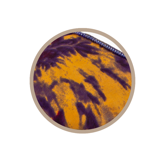 Round coaster with purple and orange pattern on a white background