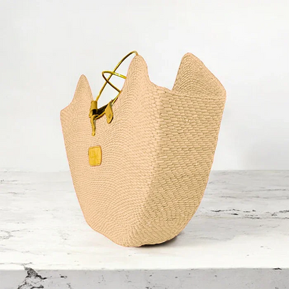 Natural straw seagrass tote bag with brass handles and a rectangular base, handcrafted in Tanzania.