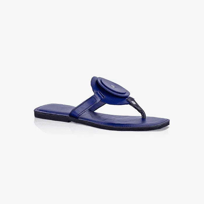 Women's blue leather flat sandals with a unique circle detail and black thong strap.