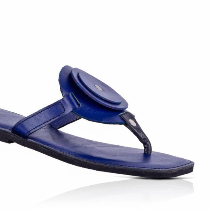 Blue sandal with a circular design on a white background