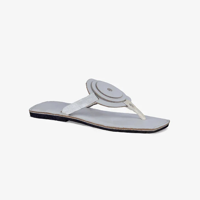 Women's white leather flat sandals with a unique circle detail and thong strap.