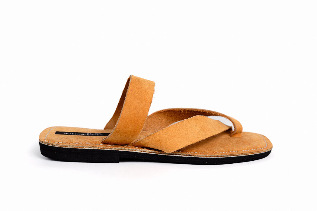 Image of handmade tan leather sandals with cross strap produced by Australian brand Miriam Bella on a white background