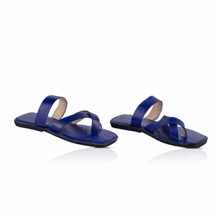 Handmade indigo leather sandals with cross strap produced by Australian brand Miriam Bella on a white background.