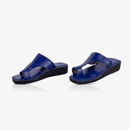 A pair of blue leather thong sandals, produced by Australian brand Miriam Bella
