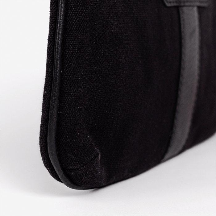 Close-up of a black textured bag on a white background