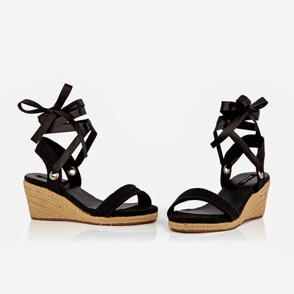 A pair of back open-toed platform espadrilles with black straps and a wedge heel, featuring a  leather lining