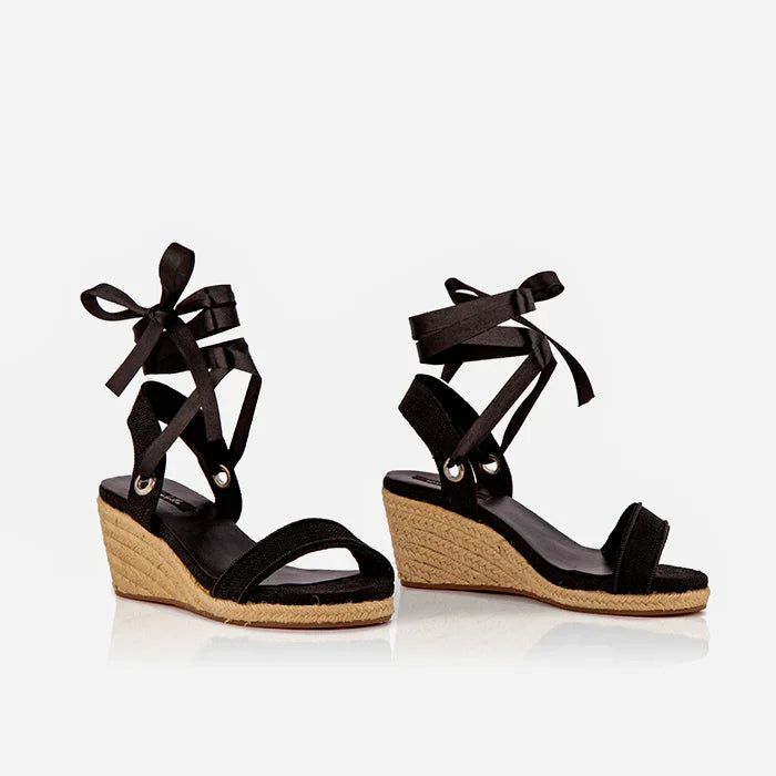 A pair of black open-toed platform espadrilles with black straps and a wedge heel, featuring a  leather lining