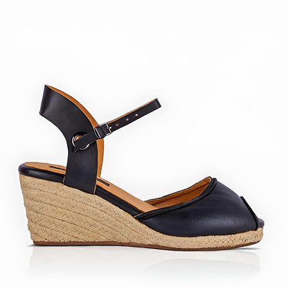 A single handcrafted leather black wedge espadrille sandals with jute sole by Miriam Bella on a white background.
