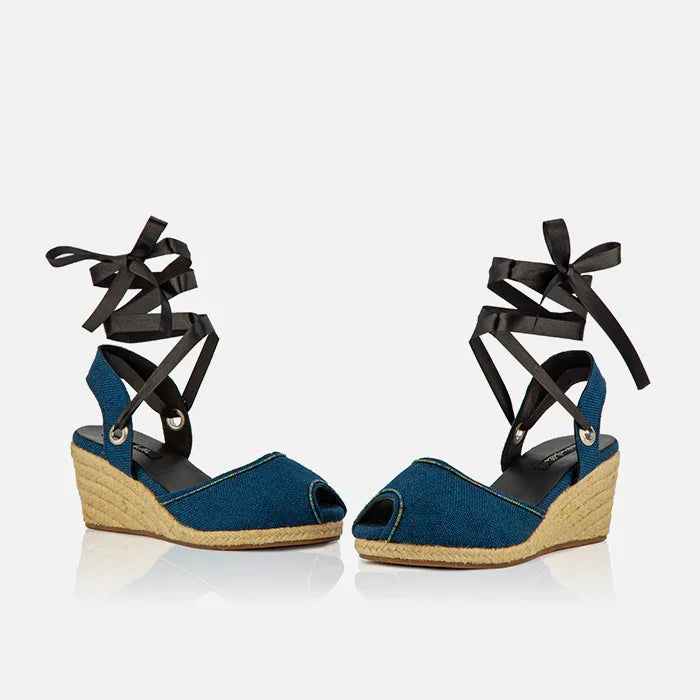 Front view of Gaia indigo canvas espadrille wedge heels with black ribbon ankle ties and peep toe design.