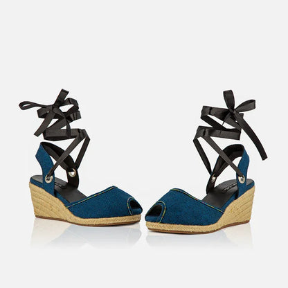 Front view of Gaia indigo canvas espadrille wedge heels with black ribbon ankle ties and peep toe design.