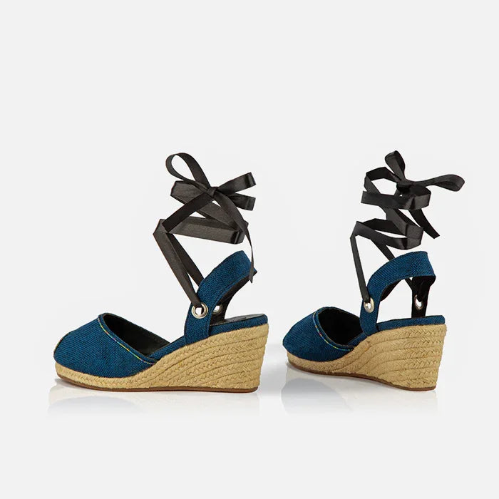Side view of Gaia indigo canvas espadrille wedge heels with black ankle ties and jute wedge heels.