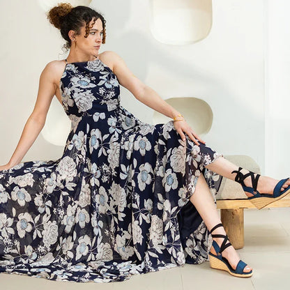 Gaia indigo canvas wedge espadrilles worn with black ribbon ankle ties and a floral dress.