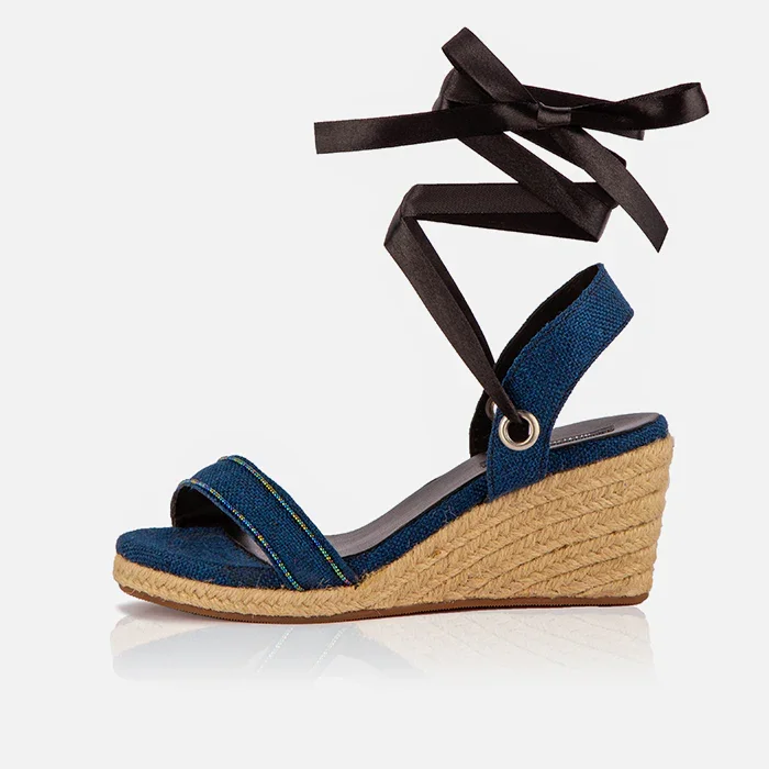 Single Gaia indigo canvas wedge espadrille with open toe, black ribbon ankle ties and jute wedge.
