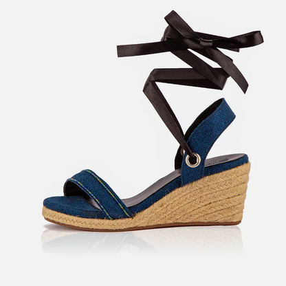 Single Gaia indigo canvas wedge espadrille with open toe, black ribbon ankle ties and jute wedge.