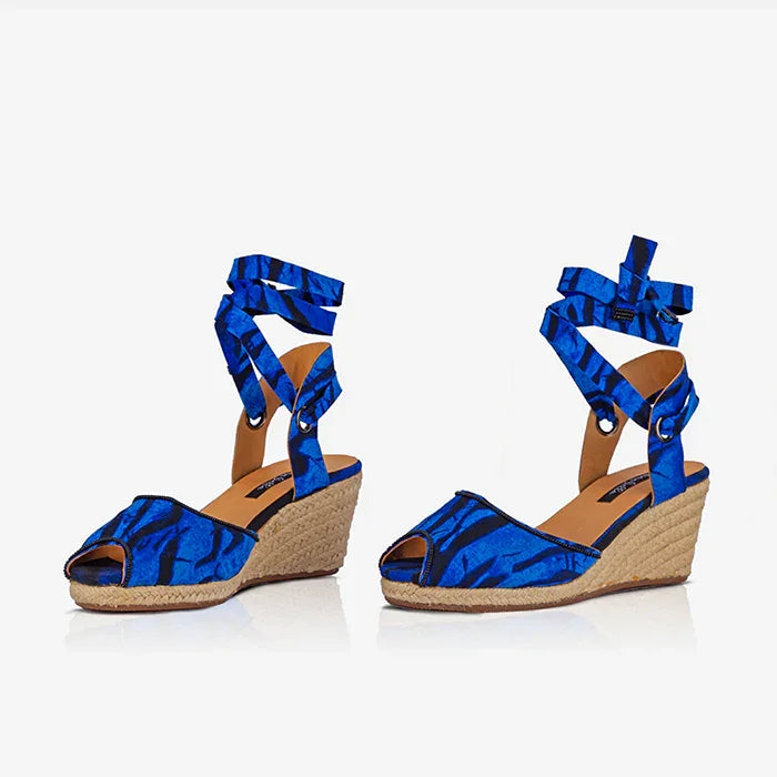 Pair of Gaia Ocean Spirit espadrille wedge sandals with blue ankle ties and printed canvas upper.