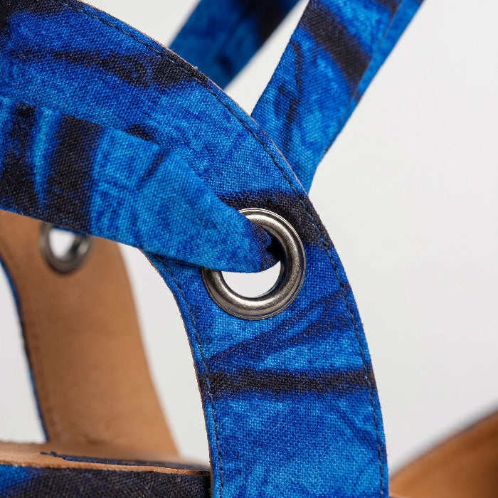 Close-up of a Gaia Ocean Spirit espadrille wedge sandal with a metal ring on a white background