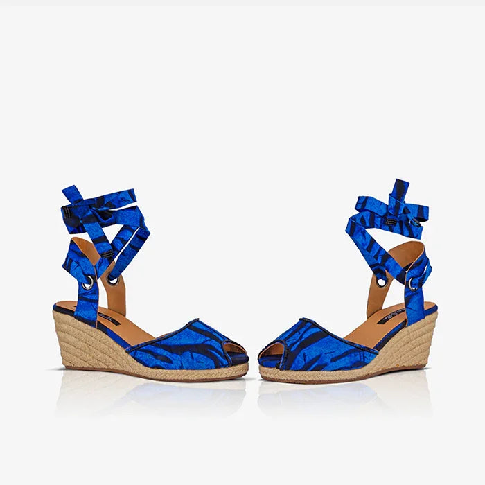 Side view of Gaia Ocean Spirit espadrille wedge sandals with blue ribbon ankle ties and jute wedge.
