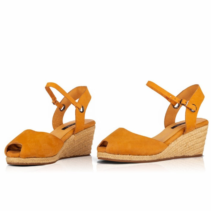 A pair of handcrafted leather ochre wedge espadrille sandals with jute sole by Miriam Bella on a white background.