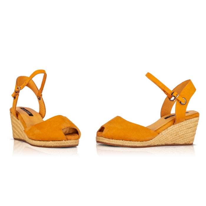 A pair of handcrafted leather ochre wedge espadrille sandals with jute sole by Miriam Bella on a white background.