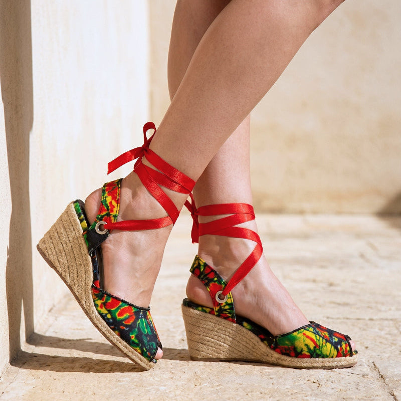 Gaia Wild Flame espadrille wedge heels with red ribbon ankle ties and printed canvas on a neutral background