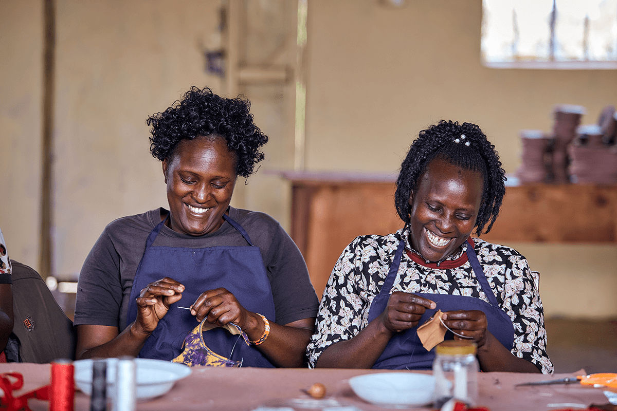 Women artisans in Kenya hand-stitching Miriam Bella handmade shoes in the workshop.