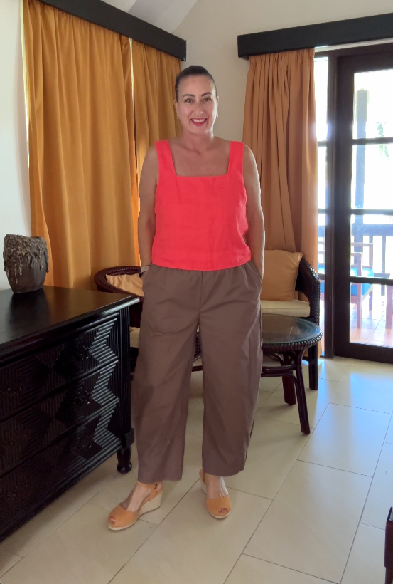 Woman wearlng ochre espadrille sandals standing in a hotel room
