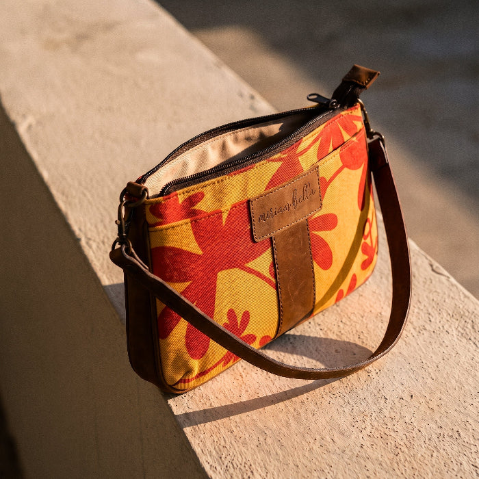 A Floral Mini Tote Bag on a stone bench.