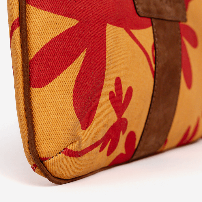 Close-up of a Floral Mini Tote Bag, bag with red floral patterns on a yellow background