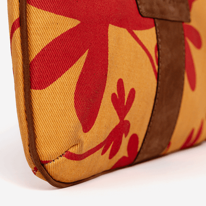 Close-up of a Floral Mini Tote Bag, bag with red floral patterns on a yellow background