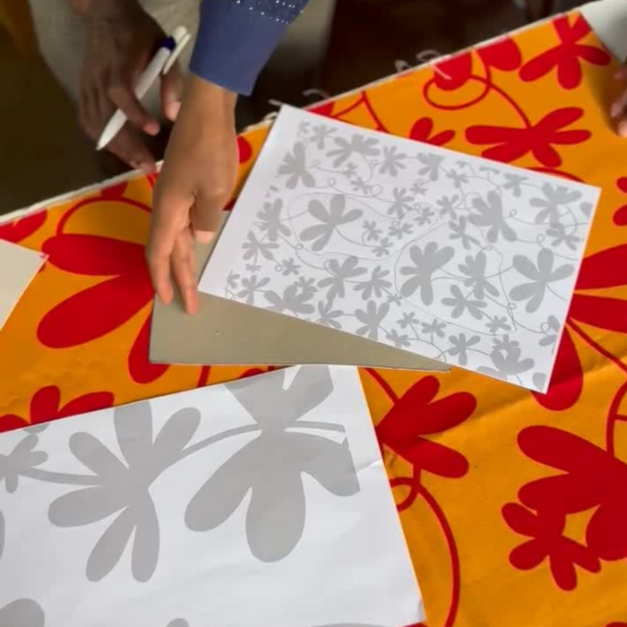 Screen printing process of the Floral Mini Tote Bag, with red floral pattern.