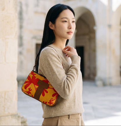 A woman holding the Floral Mini Tote Bag on her right shoulder.
