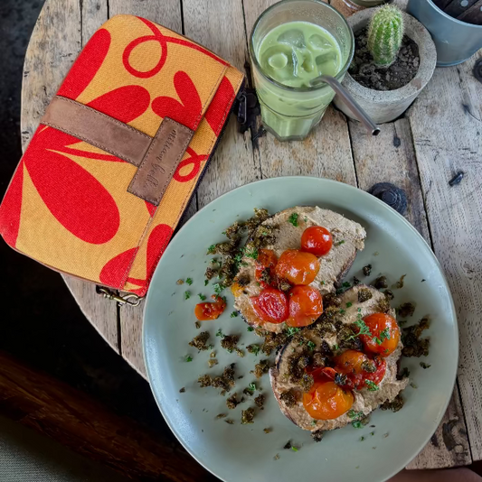 Plate of food with a drink and the Floral Mini Tote Bag on a wooden table