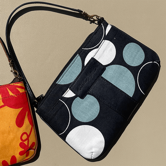 Black Print Mini Tote Bag for Women with circular patterns on a beige background 