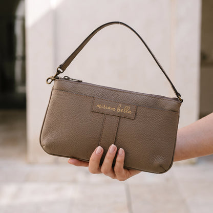 A hand holding the Mini Tote.