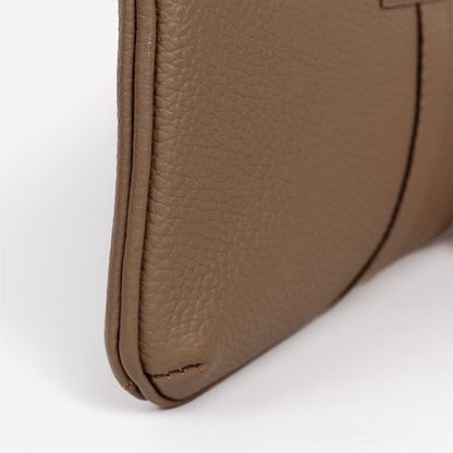 Close-up of a the Mini Tote in brown leather wallet corner on a white background
