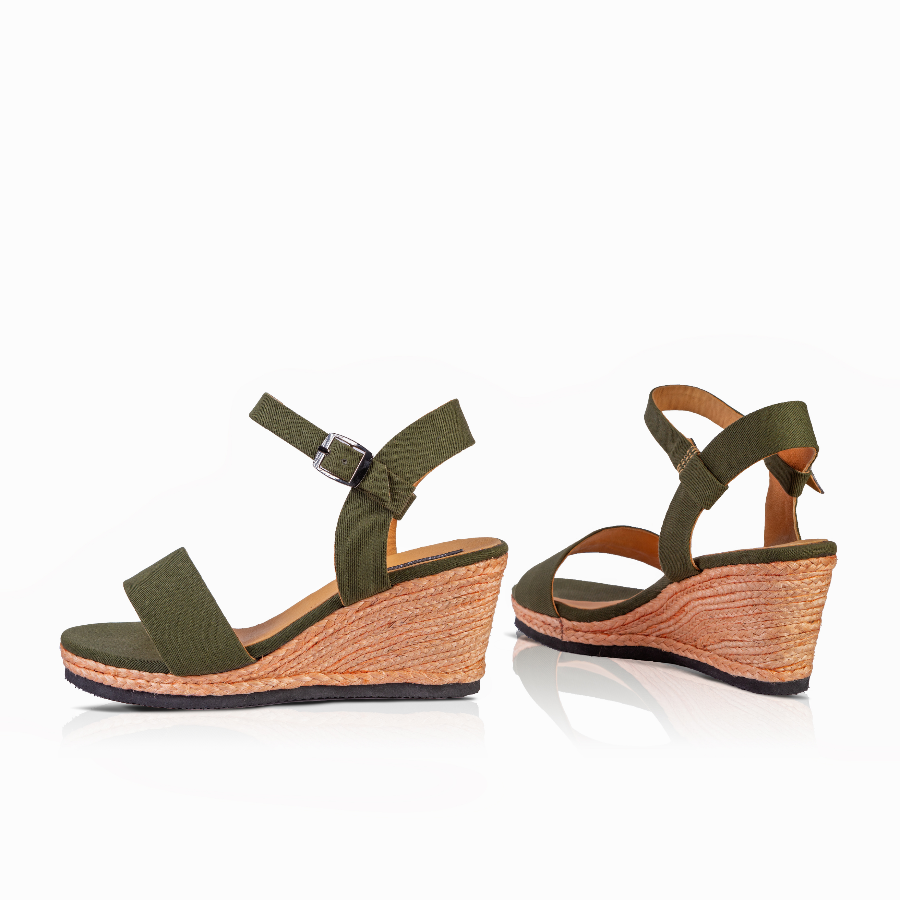 A pair of women's wedge sandals in olive green with a knotted front detail, adjustable ankle straps, and a natural jute wedge heel, shown on a white background.
