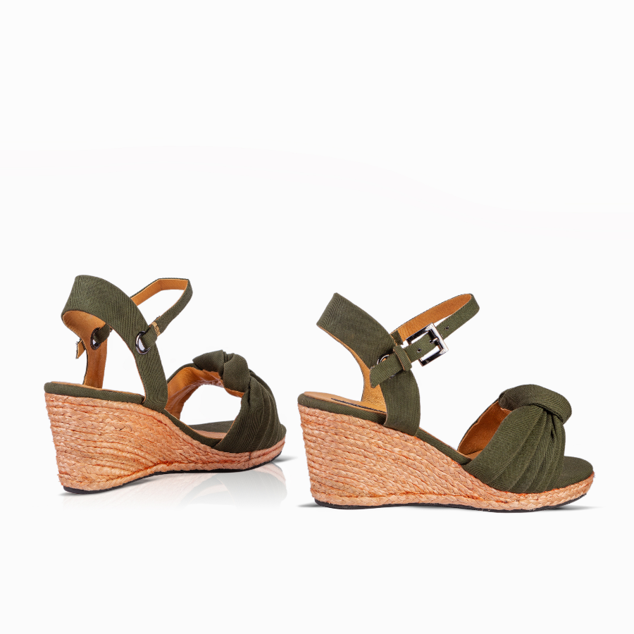A pair of women's wedge sandals in olive green with braided jute wedge sandals and adjustable ankle straps, shown from the side against a white background.