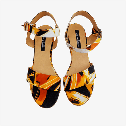 Pair of sandals with a colorful pattern on a white background