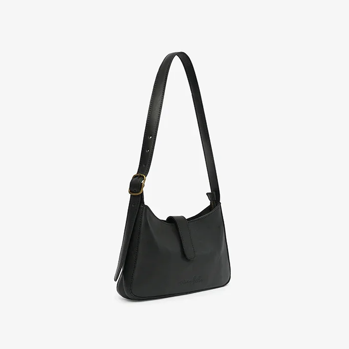 A black leather mini shoulder bag on a light gray background