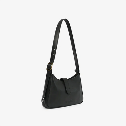 A black leather mini shoulder bag on a light gray background