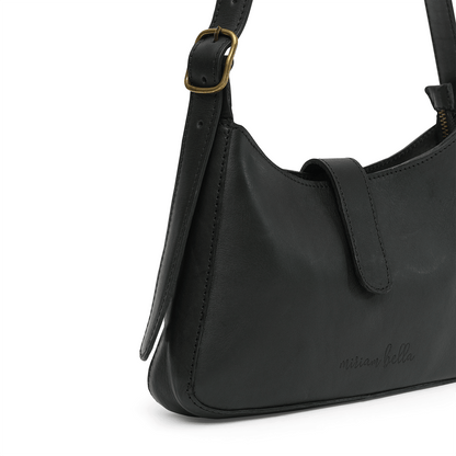 A black leather mini shoulder bag with gold buckle on a white background