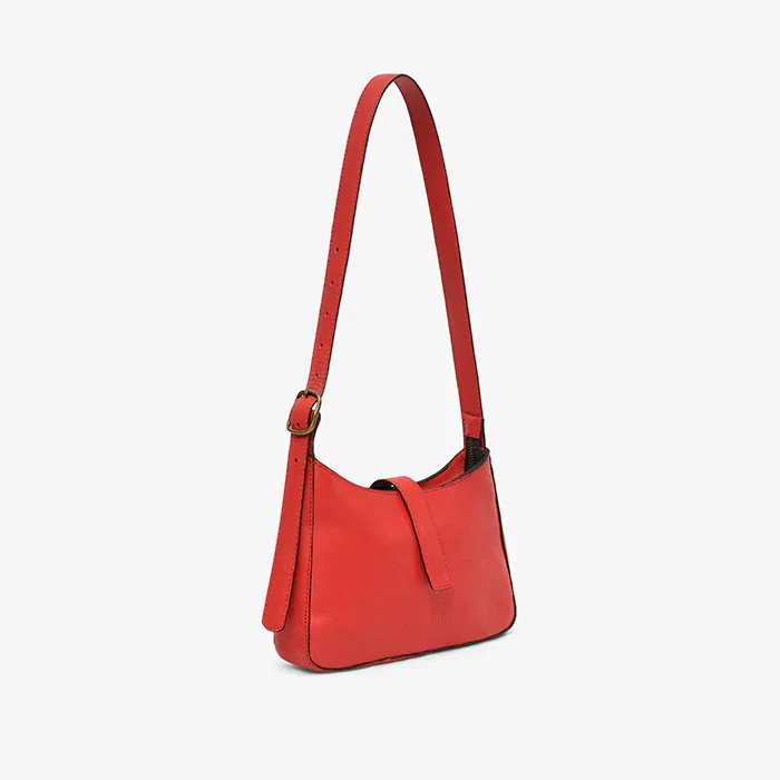 A red leather mini shoulder bag on a light gray background