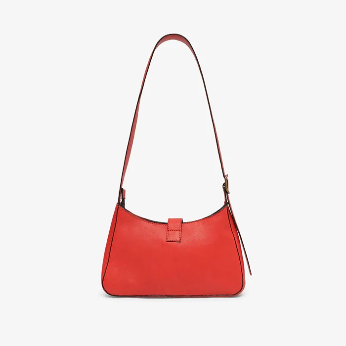 A red leather mini shoulder bag with a strap on a light gray background
