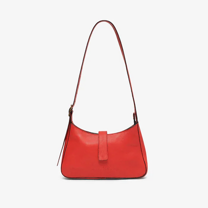 Red leather mini shoulder bag  with a strap on a light gray background